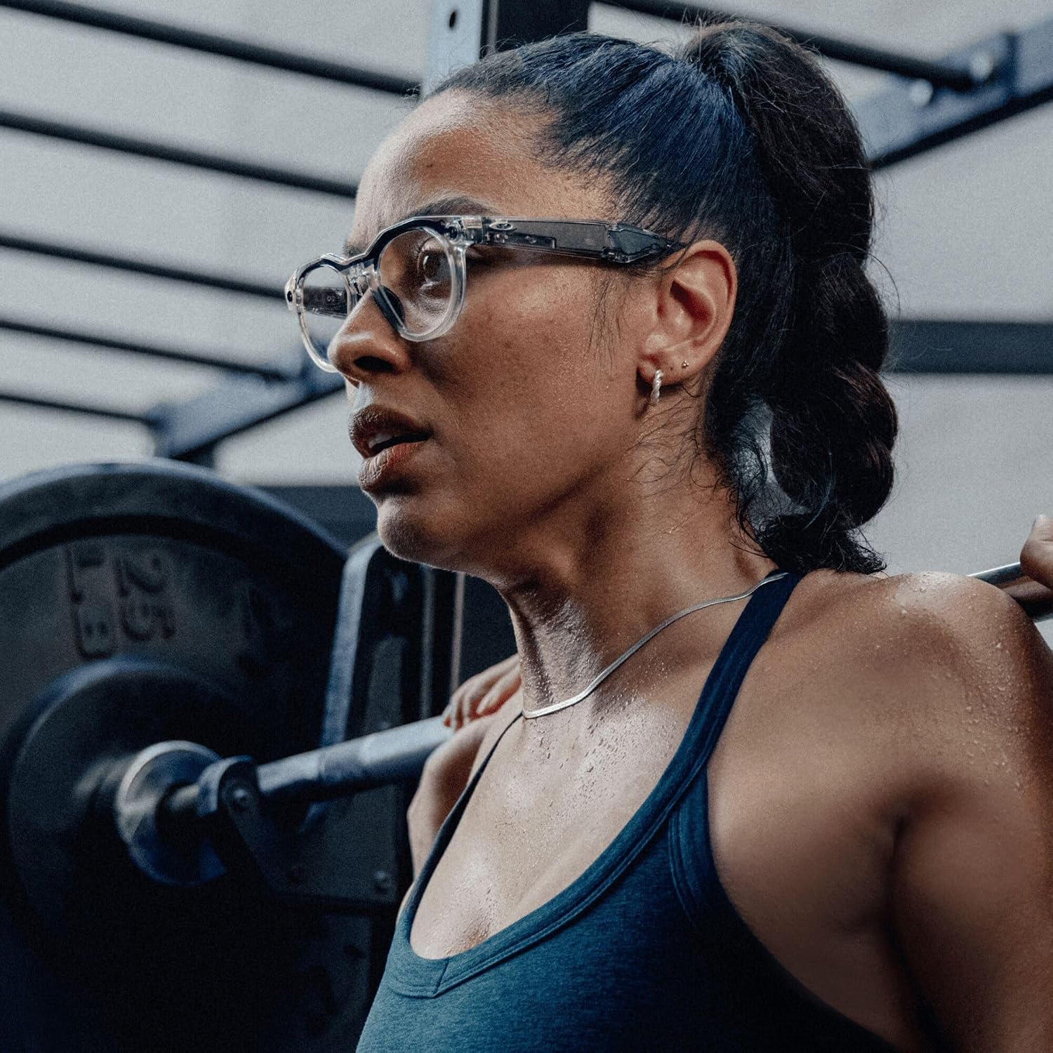 AI smart glasses with clear frame and Transitions grey lenses, front and side view — view 2