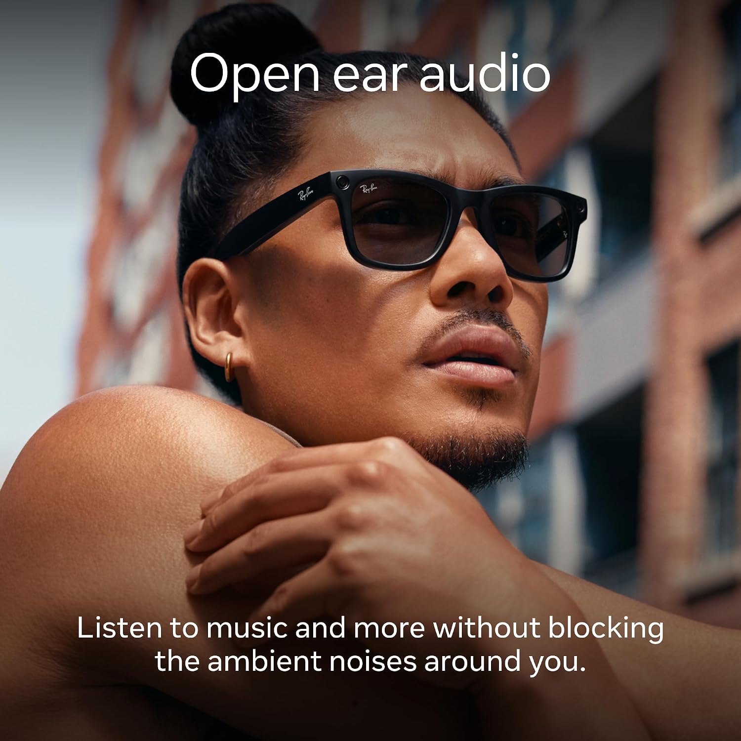 Sleek black smart glasses with ultra-wide camera lens and open-ear speaker design, front and side view โ detail